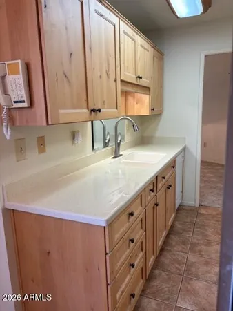 a kitchen with stainless steel appliances a sink and a refrigerator