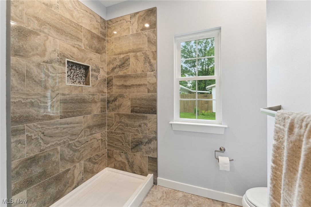 7605 Lake Road East Madison, OH 44057 - Photo 22 of 50 Full bath featuring baseboards, tiled shower, and toilet