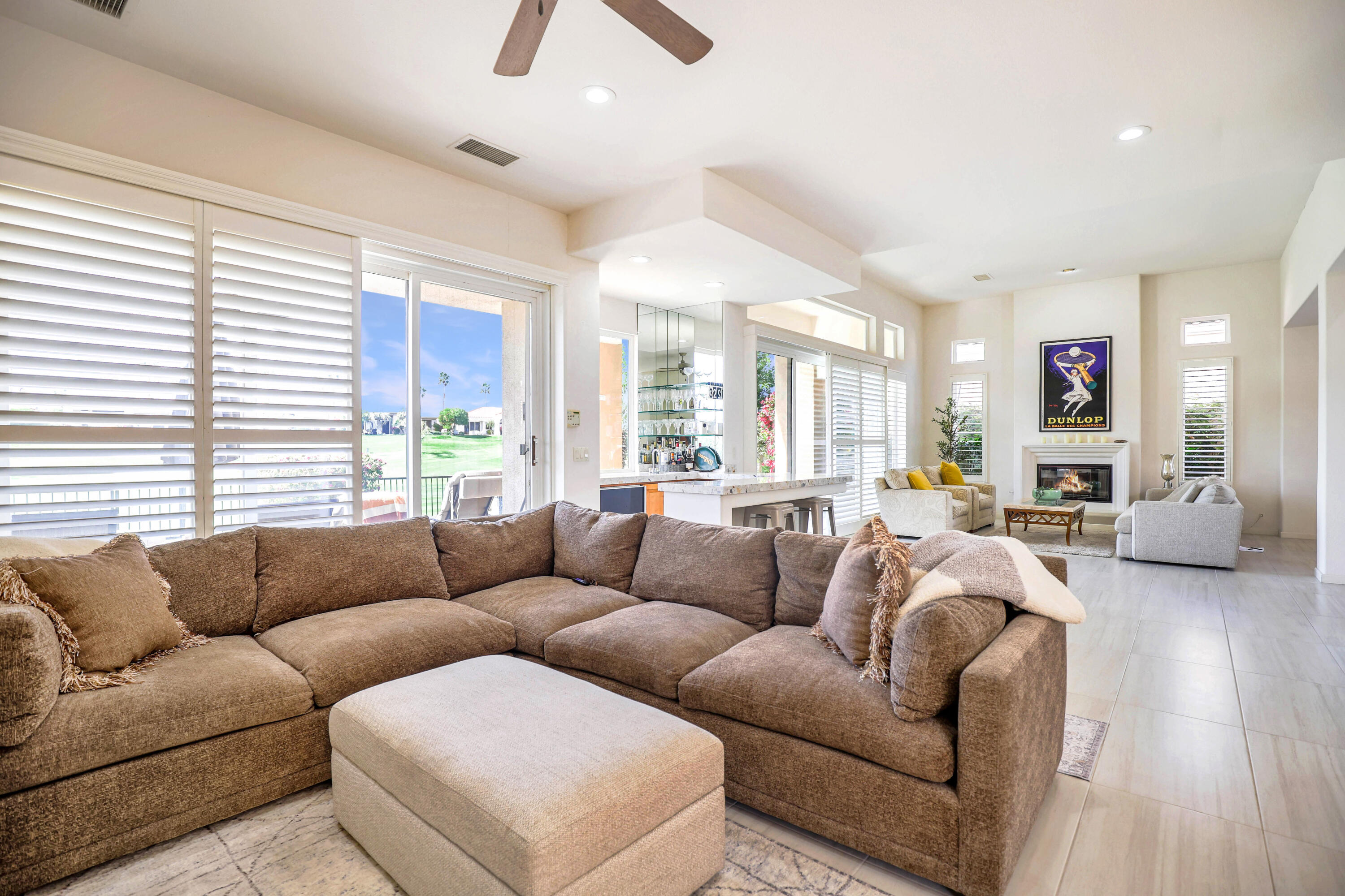 371 Tomahawk Drive Palm Desert, CA 92211 - Photo 12 of 34 a living room with furniture kitchen view and a large window