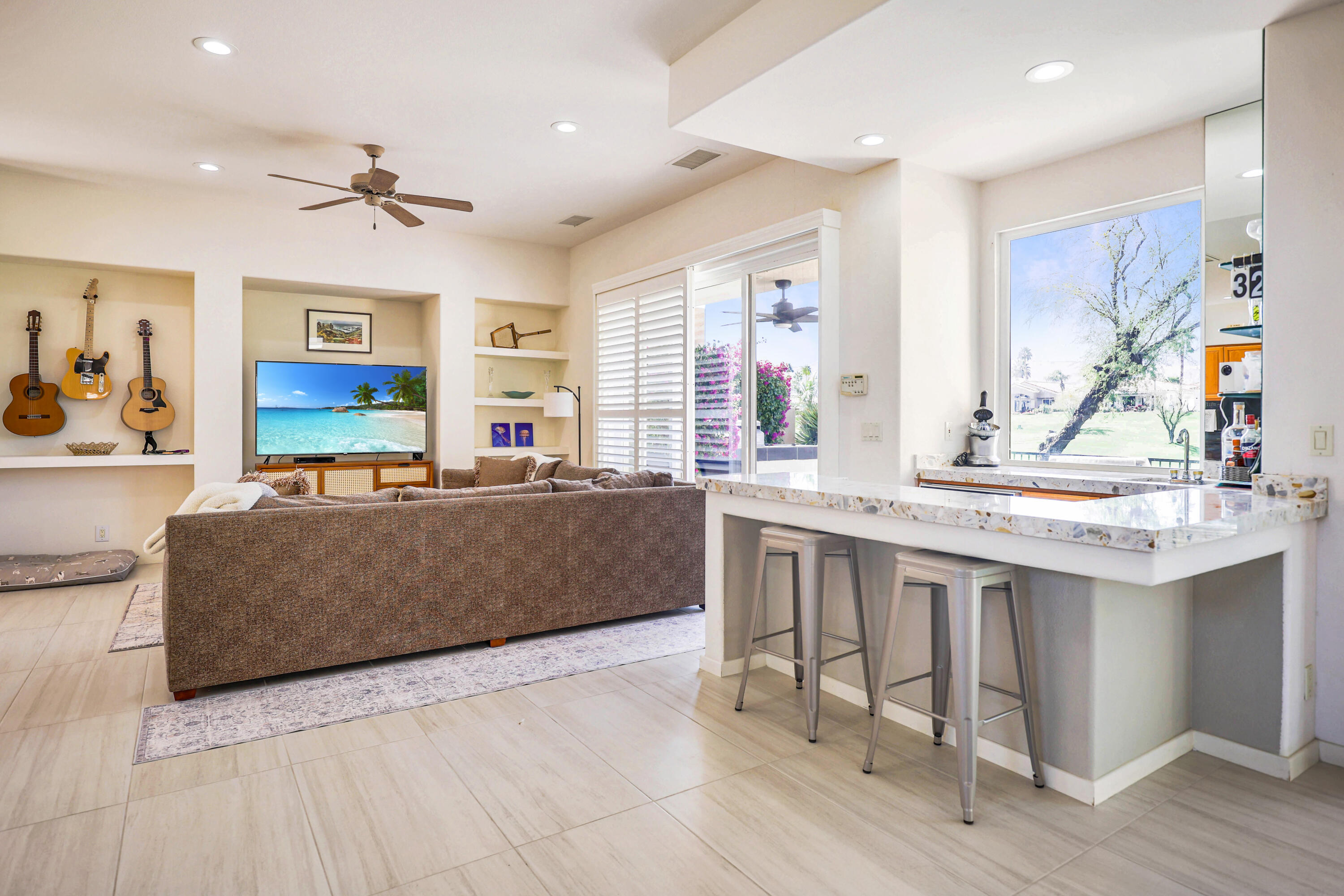 371 Tomahawk Drive Palm Desert, CA 92211 - Photo 13 of 34 a living room with furniture a large window and wooden floors