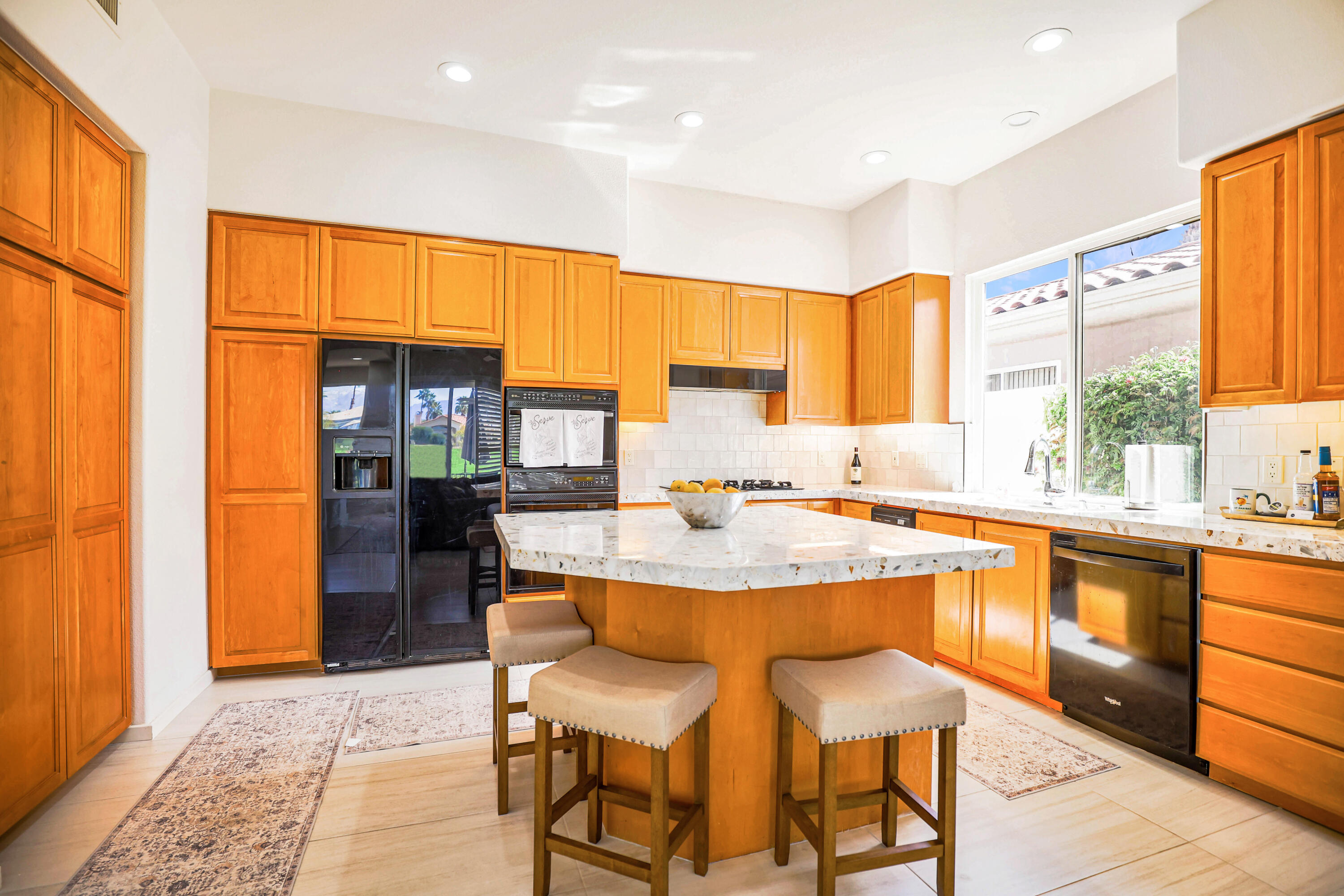 371 Tomahawk Drive Palm Desert, CA 92211 - Photo 15 of 34 a dining hall with stainless steel appliances granite countertop a sink and a large window