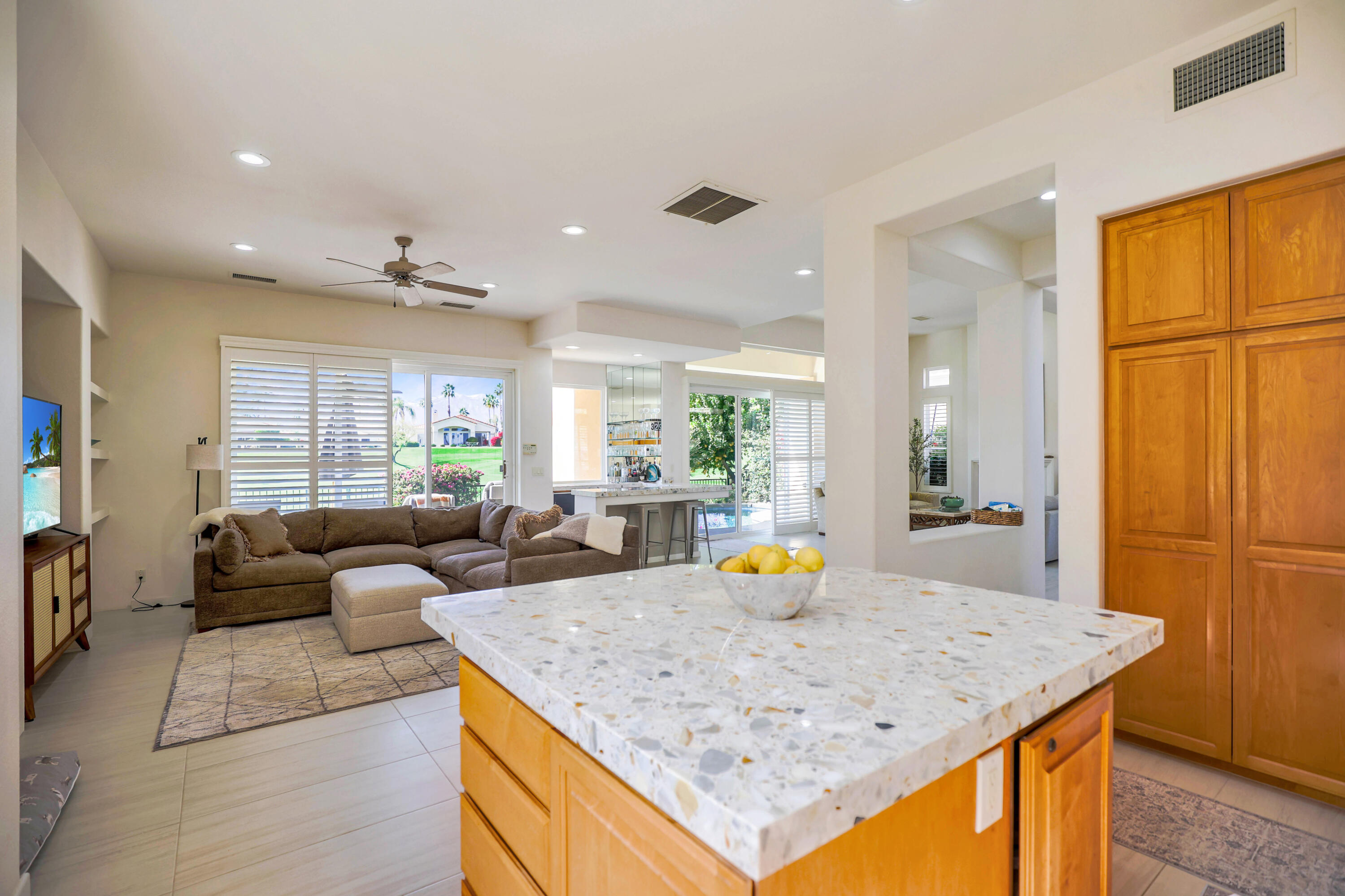 371 Tomahawk Drive Palm Desert, CA 92211 - Photo 16 of 34 a view of kitchen island with granite countertop furniture and living room