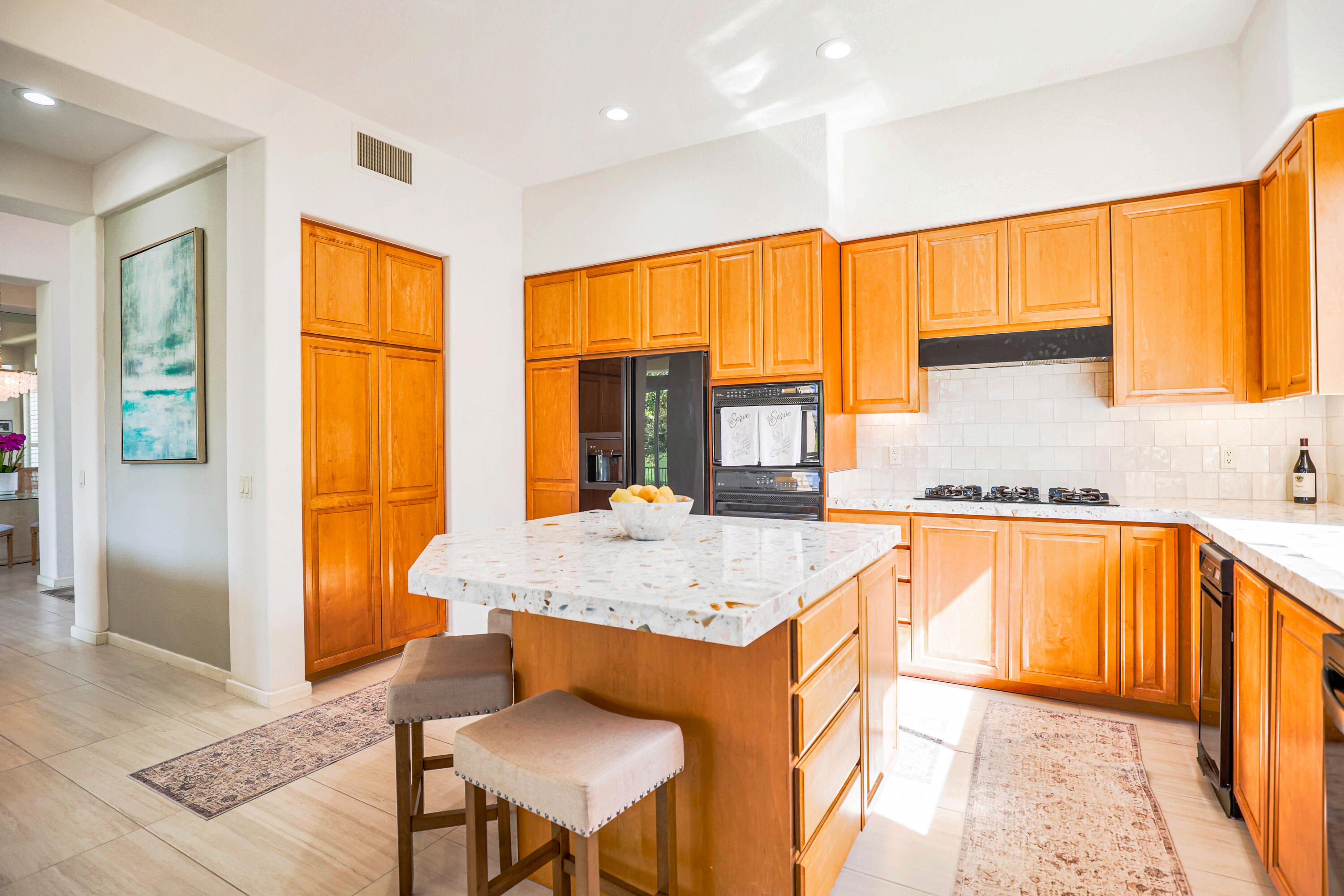 371 Tomahawk Drive Palm Desert, CA 92211 - Photo 17 of 34 a kitchen with granite countertop sink and cabinets
