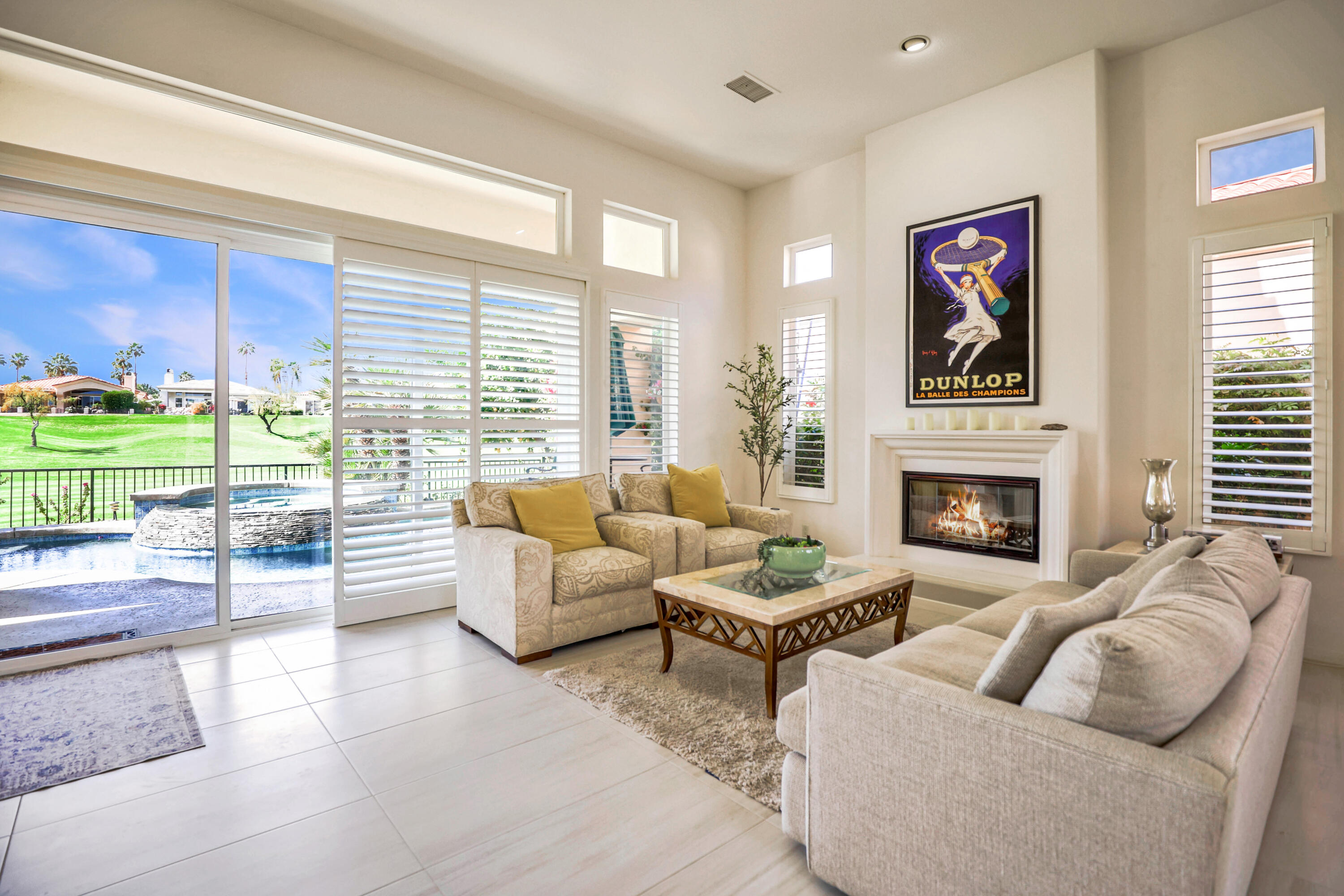 371 Tomahawk Drive Palm Desert, CA 92211 - Photo 8 of 34 a living room with furniture large window and a fireplace