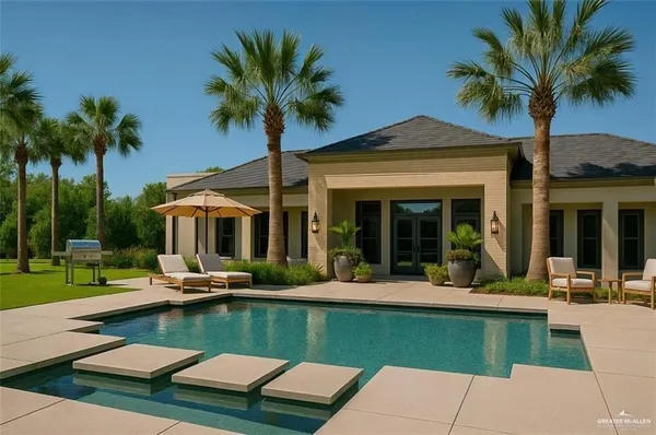 a view of a house with swimming pool lawn chairs and a small yard