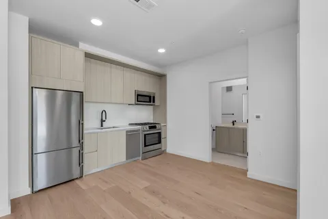 a kitchen with cabinets and stainless steel appliances