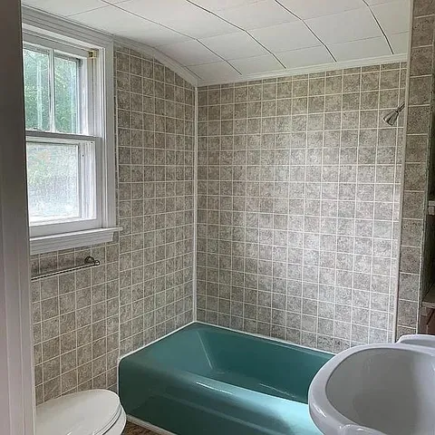 a bathroom with a sink toilet and shower