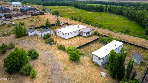 an aerial view of a house with garden space and ocean view