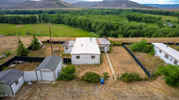 an aerial view of a house with garden space and street view