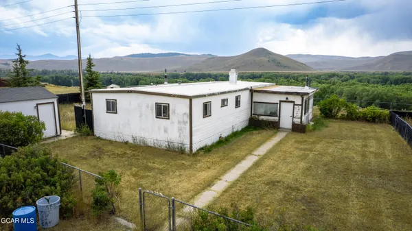 a view of a house with a yard and sitting area