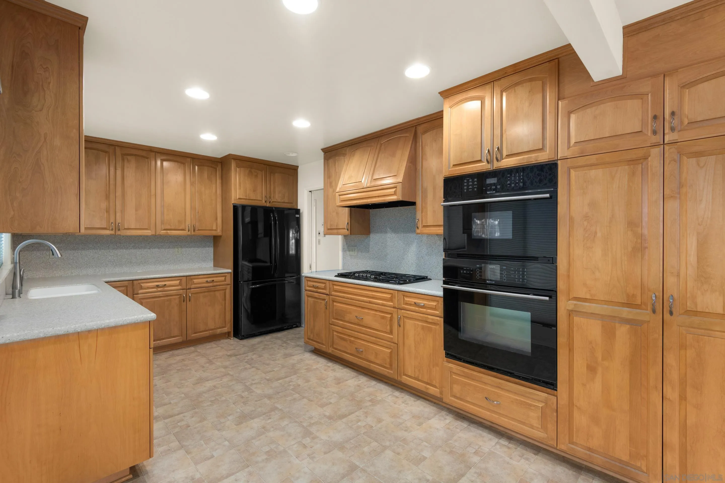 486 Murray Drive El Cajon, CA 92020 - Photo 7 of 23 a kitchen with granite countertop stainless steel appliances and refrigerator
