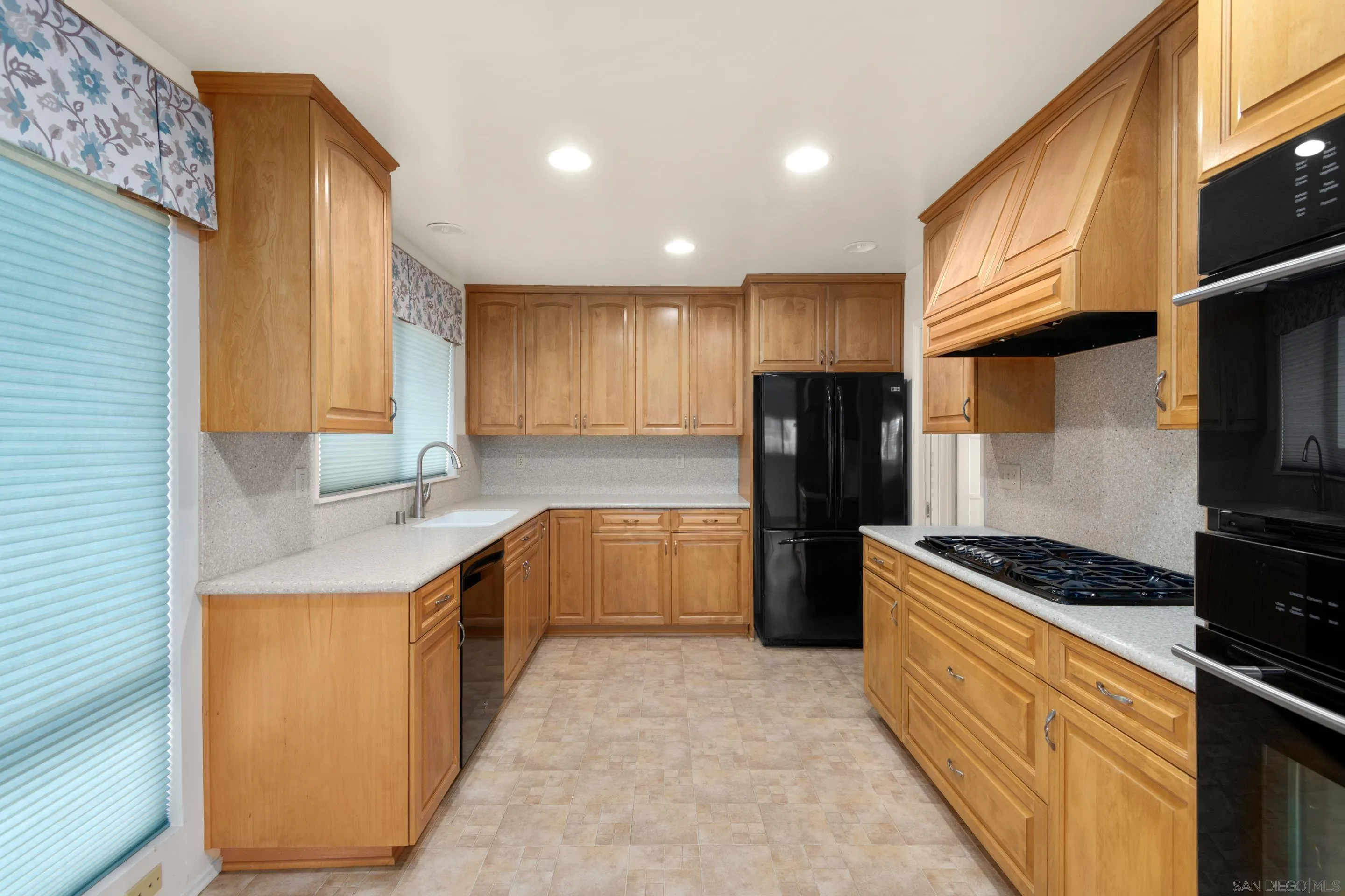 486 Murray Drive El Cajon, CA 92020 - Photo 8 of 23 a kitchen with stainless steel appliances granite countertop a stove a sink and a refrigerator