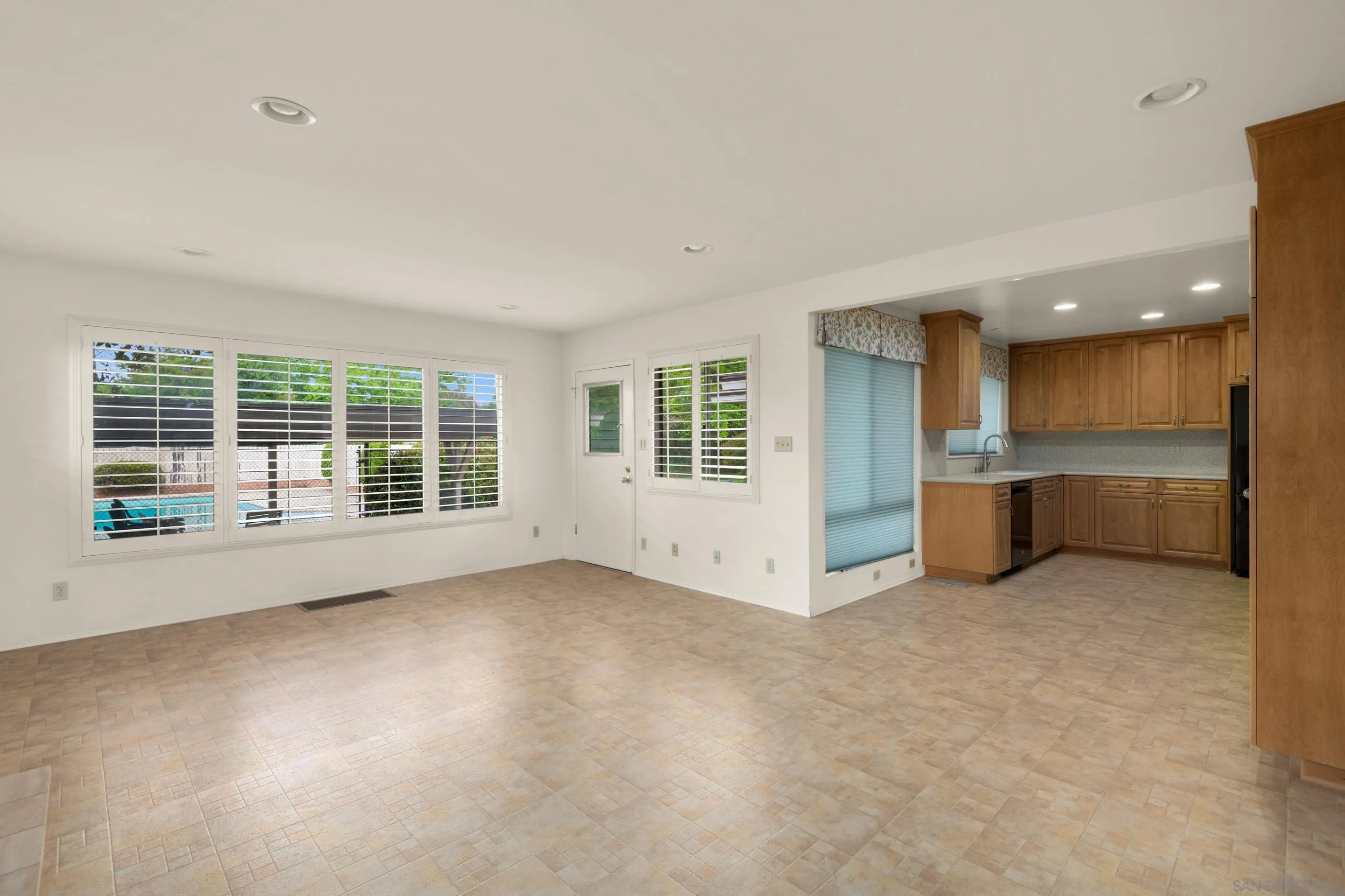 486 Murray Drive El Cajon, CA 92020 - Photo 10 of 23 an empty room with a kitchen and large windows