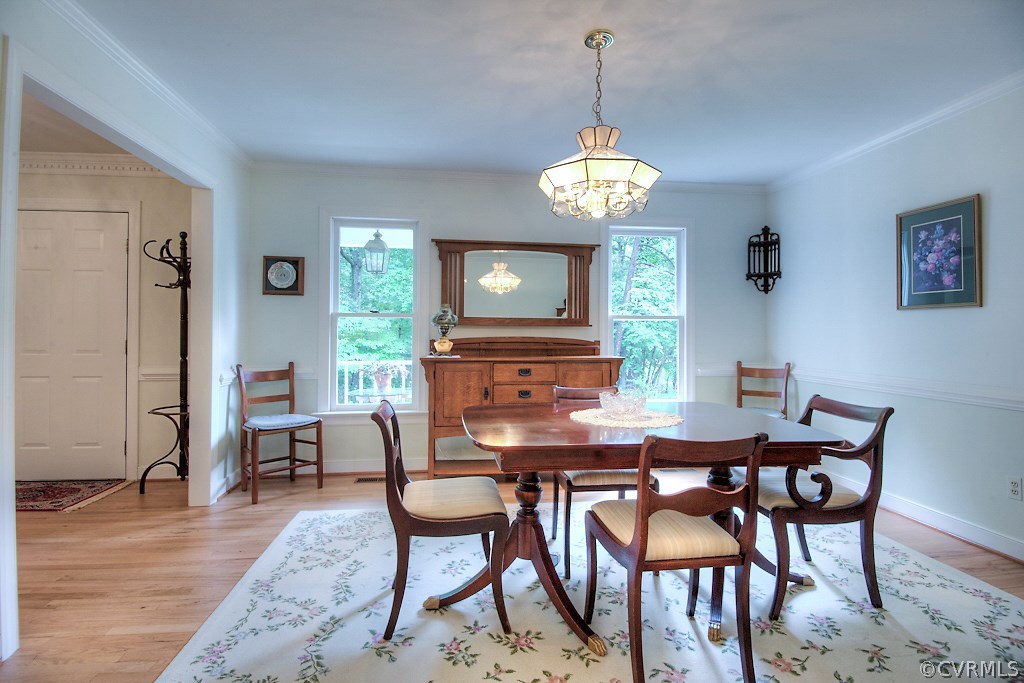 5502 Manitoba Road Chesterfield, VA 23832 - Photo 19 of 48 a view of a dining room with furniture a chandelier and wooden floor
