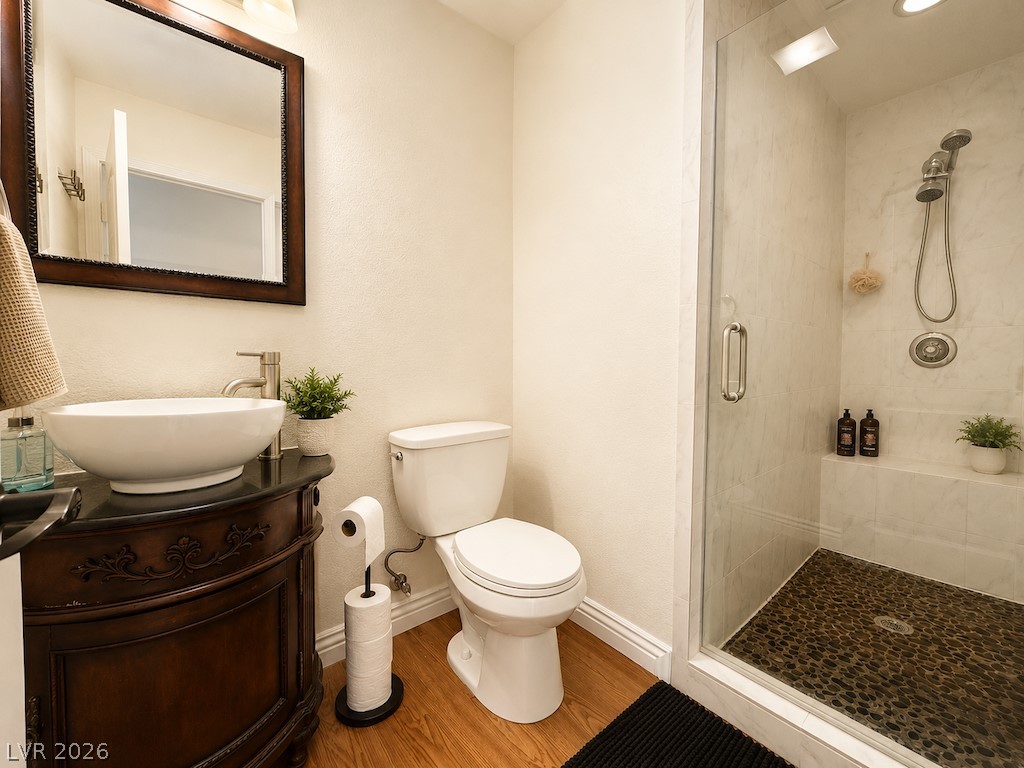 3010 East Viking Road Las Vegas, NV 89121 - Photo 11 of 48 A vessel sink vanity and a sleek glass-enclosed shower elevate this polished bathroom's design.