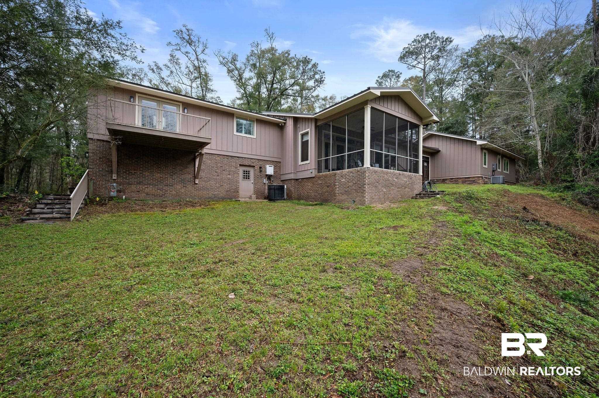 7850 Yorkhaven Road Mobile, AL 36695 - Photo 45 of 57 Back of property featuring central AC, a lawn, brick siding, and a sunroom