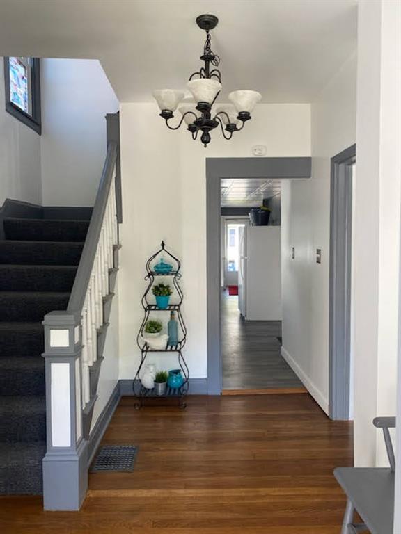 234 Marwood Road Cabot, PA 16023 - Photo 6 of 22 a hallway with wooden floor staircase and a chandelier