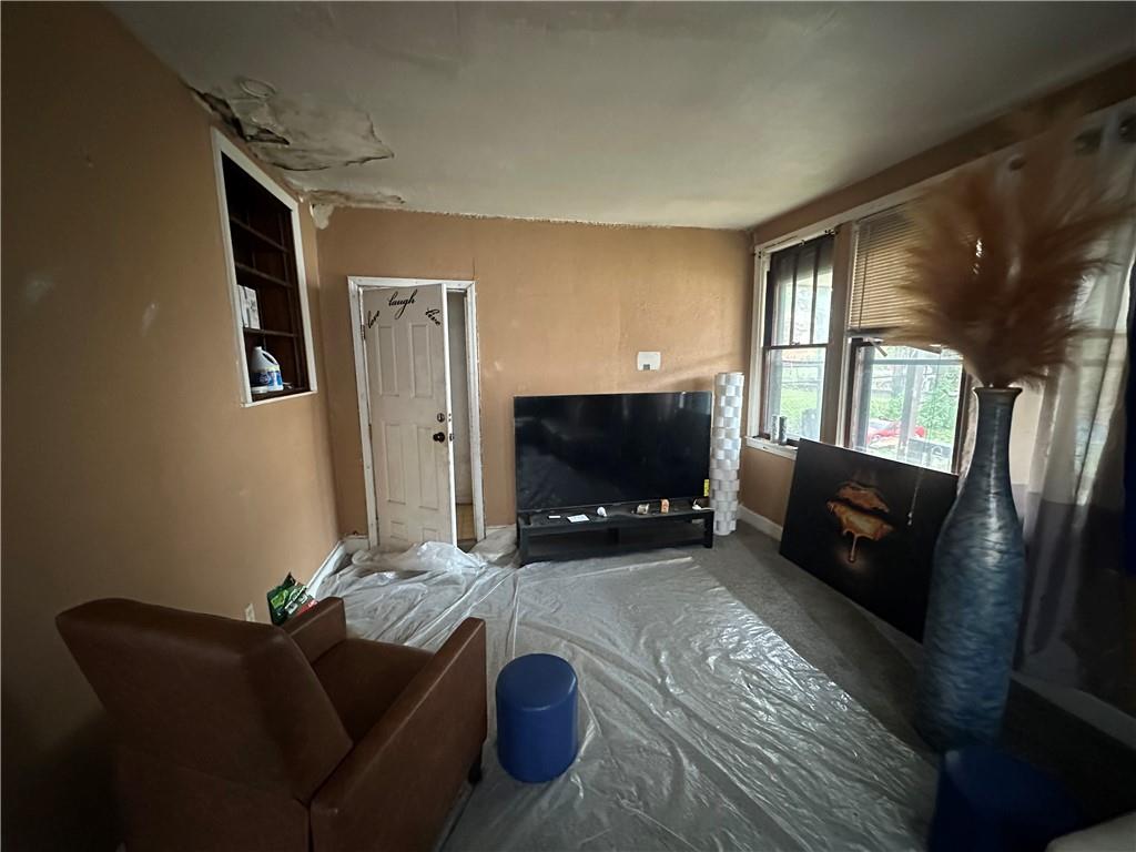 200 Copeland Street McKees Rocks, PA 15136 - Photo 16 of 39 a living room with furniture a flat screen tv and a fireplace