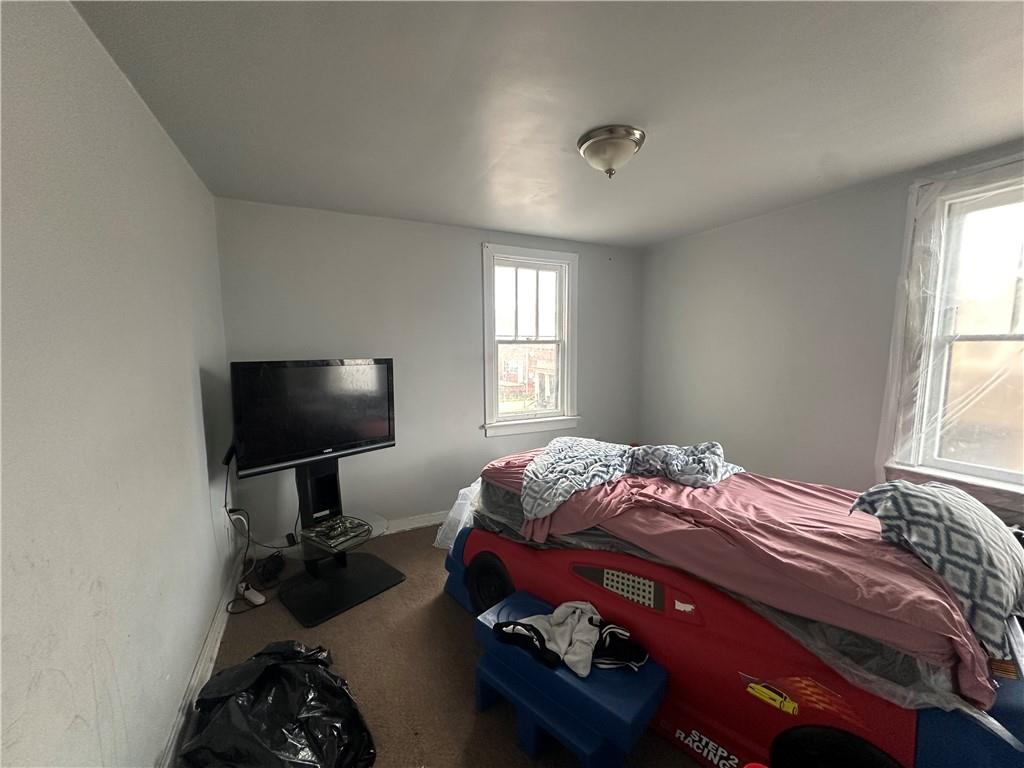 200 Copeland Street McKees Rocks, PA 15136 - Photo 19 of 39 a bedroom with a bed and a flat tv screen on the dresser