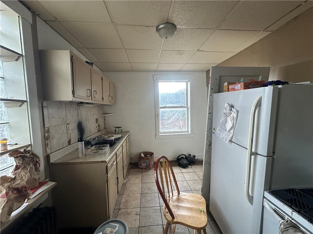 200 Copeland Street McKees Rocks, PA 15136 - Photo 20 of 39 a kitchen with a refrigerator a stove a sink and a window