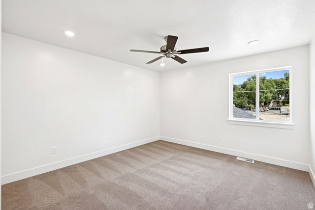1615 North Angel Street West Layton, UT 84041 - Photo 8 of 22 Spare room featuring light carpet, a ceiling fan, and recessed lighting