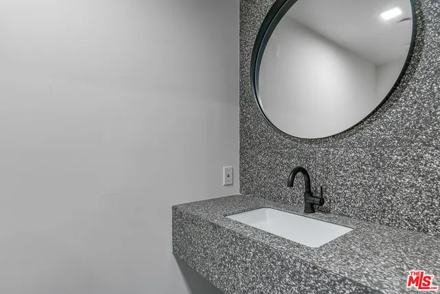 a bathroom with a sink and mirror