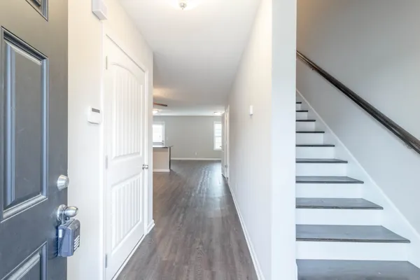 a view of a hallway with wooden floor and entryway