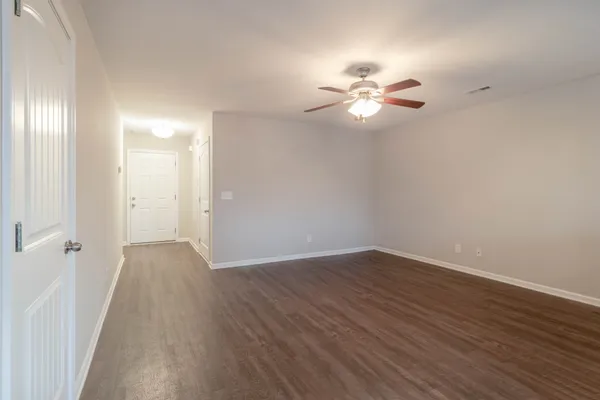 a view of empty room with wooden floor