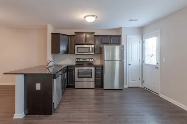 a kitchen with a refrigerator and a sink