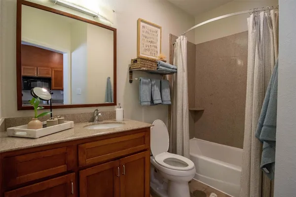 a bathroom with a double vanity sink toilet mirror and shower