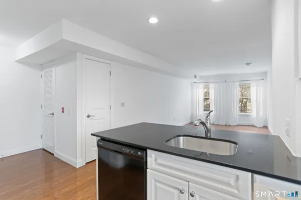 a kitchen with granite countertop a sink and a stove