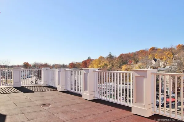 a view of a balcony with wooden fence and floor