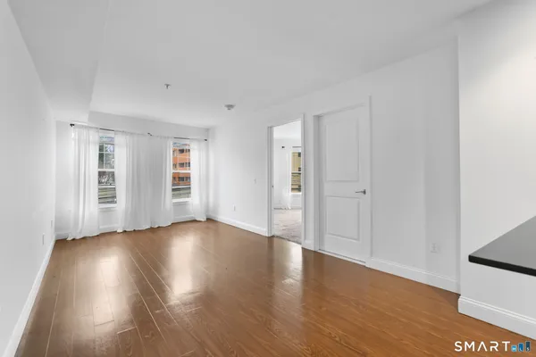 a view of wooden floor and windows in a room