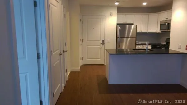 a kitchen with stainless steel appliances a refrigerator and a stove top oven