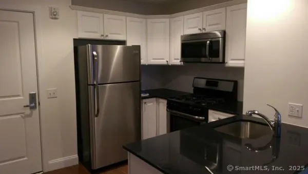 a kitchen with a refrigerator stove and microwave