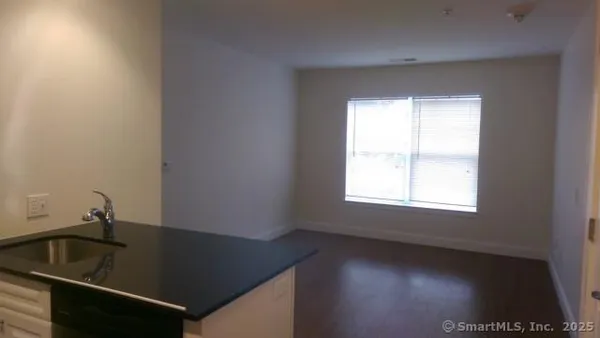 a view of a sink a window and a kitchen counter space