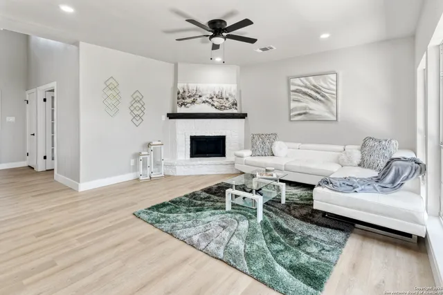 a living room with furniture and a fireplace