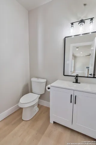 a bathroom with a toilet sink and mirror