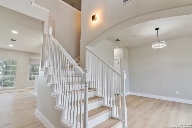 a view of staircase with white walls and windows