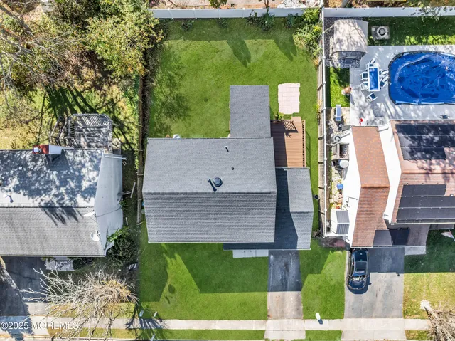 an aerial view of a house with a swimming pool