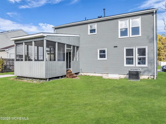 a view of a house with a yard and sitting area