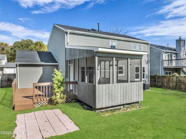 a view of a house with backyard and porch