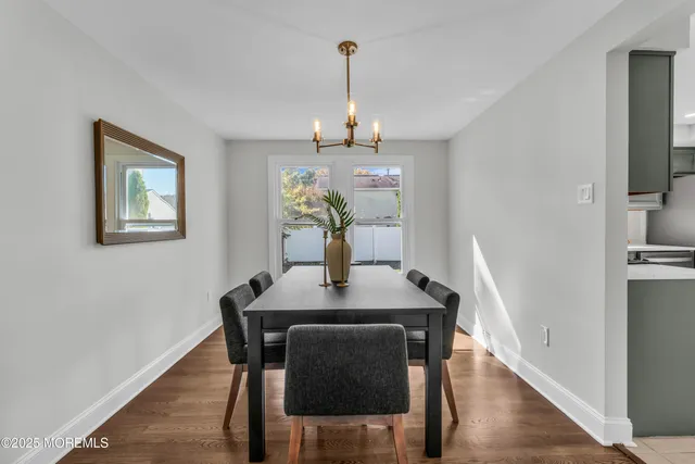 a view of a dining room with furniture wooden floor and a chandelier