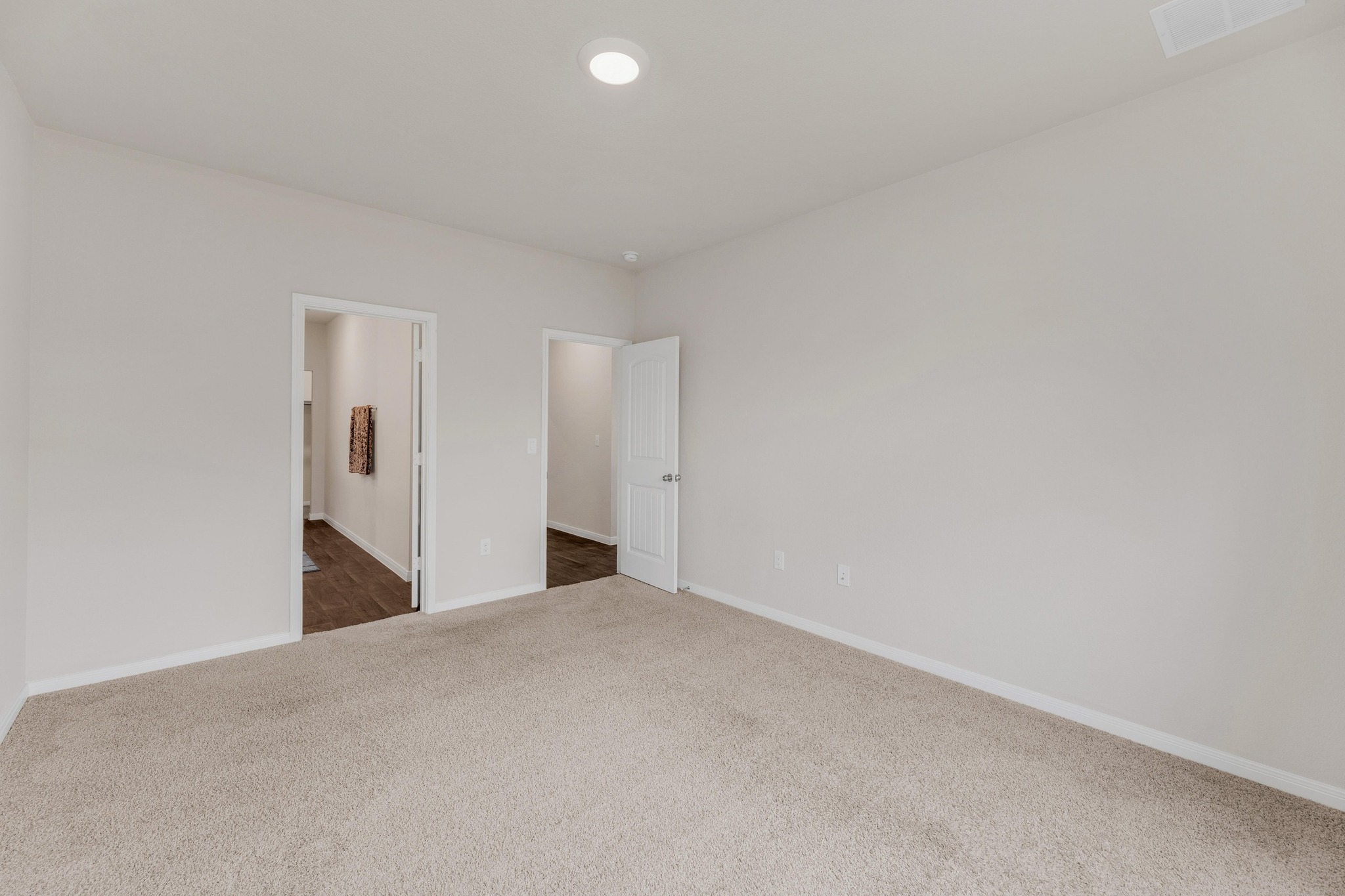 2900 Tweedy Trail Pflugerville, TX 78660 - Photo 13 of 33 Unfurnished bedroom with dark colored carpet, baseboards, and ensuite bathroom