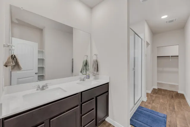 a bathroom with a sink double vanity and a mirror