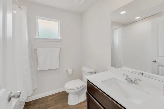 a bathroom with a sink toilet and vanity