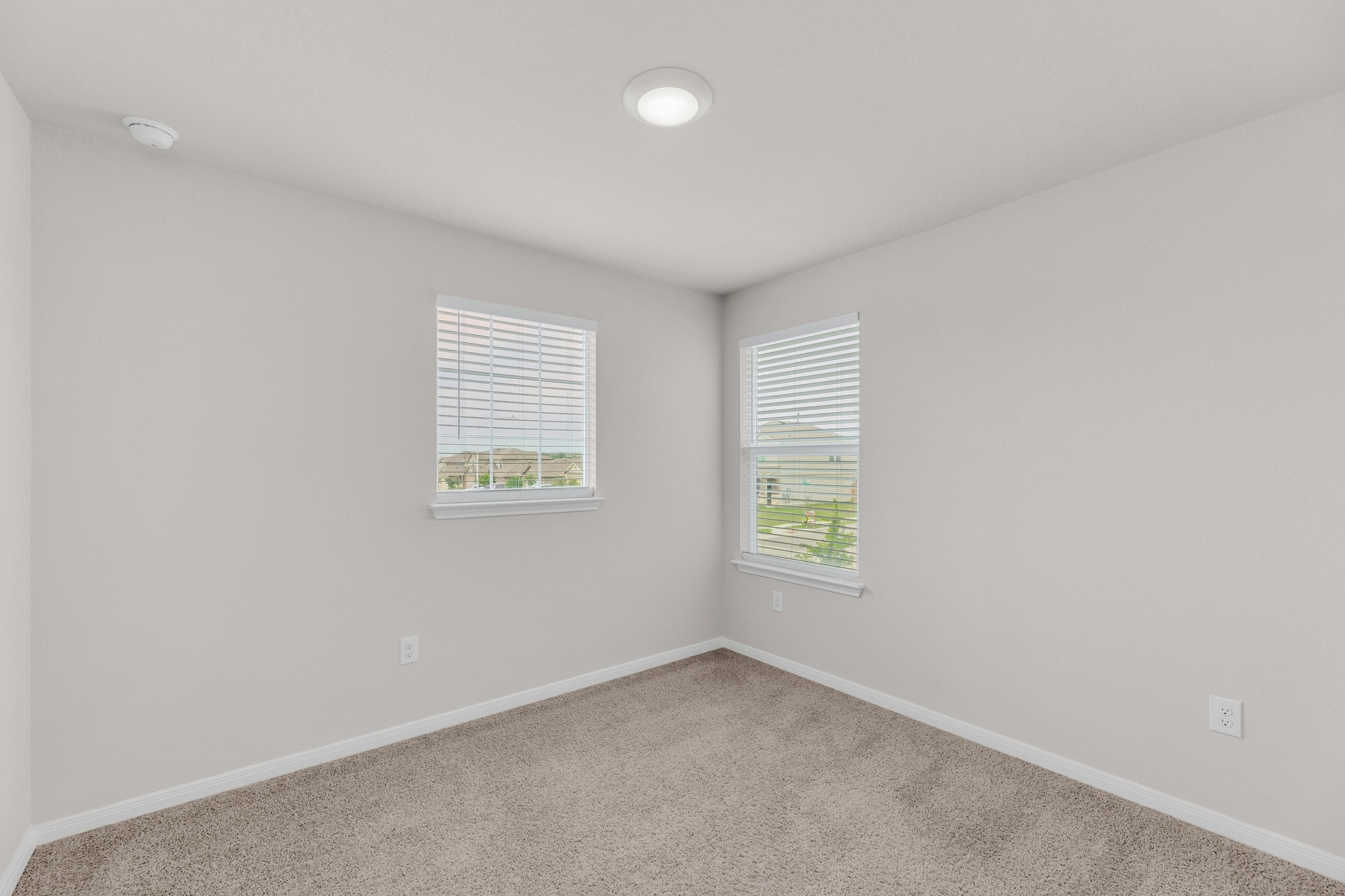 2900 Tweedy Trail Pflugerville, TX 78660 - Photo 20 of 33 Spare room featuring carpet floors, baseboards, and a smoke detector
