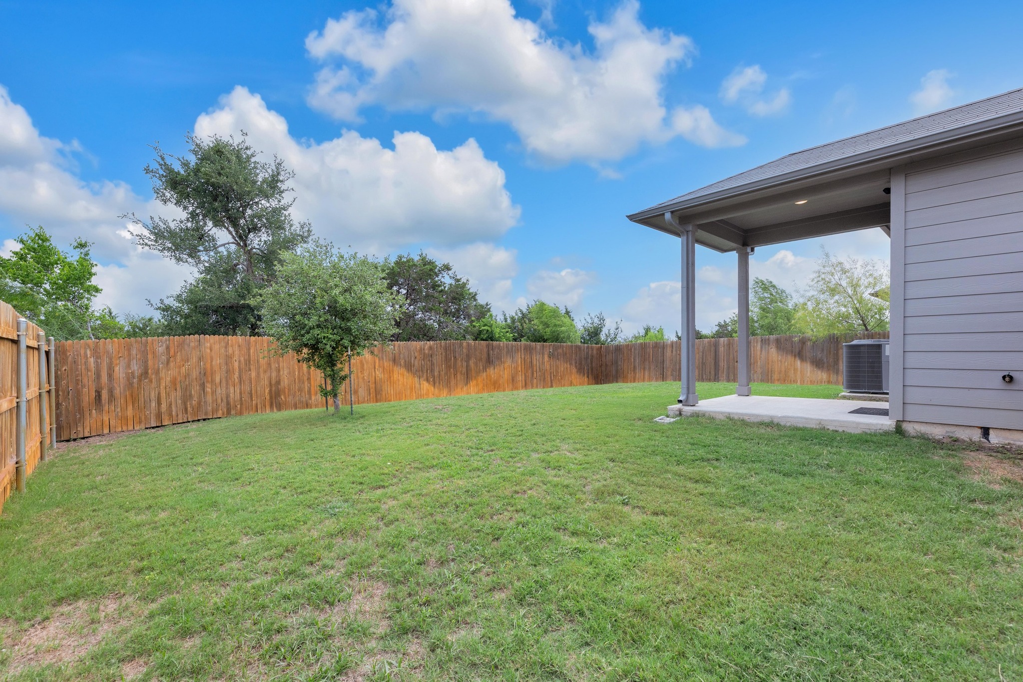 2900 Tweedy Trail Pflugerville, TX 78660 - Photo 22 of 33 View of yard featuring a patio area and central air condition unit