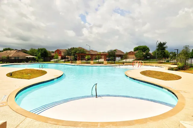 a view of a swimming pool with a yard