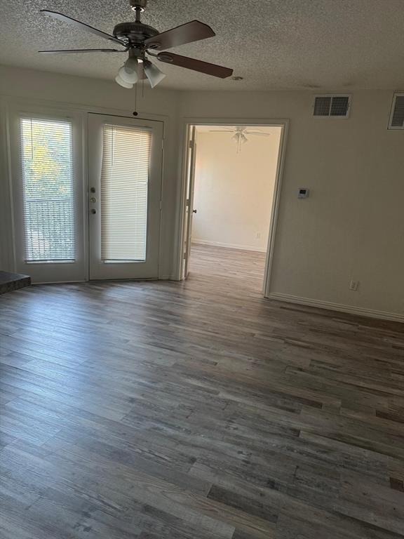 9825 Walnut Street, Unit 305 Dallas, TX 75243 - Photo 4 of 9 a view of an empty room with wooden floor and a window